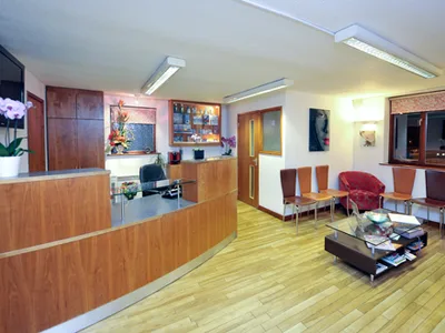 Wooden reception desk and waiting area inside Dental Studio