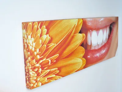 Canvas print of a smile beside an orange gerbera on the practice wall